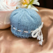 Hand knitted newborn baby gift set comprising of mittens hat and booties